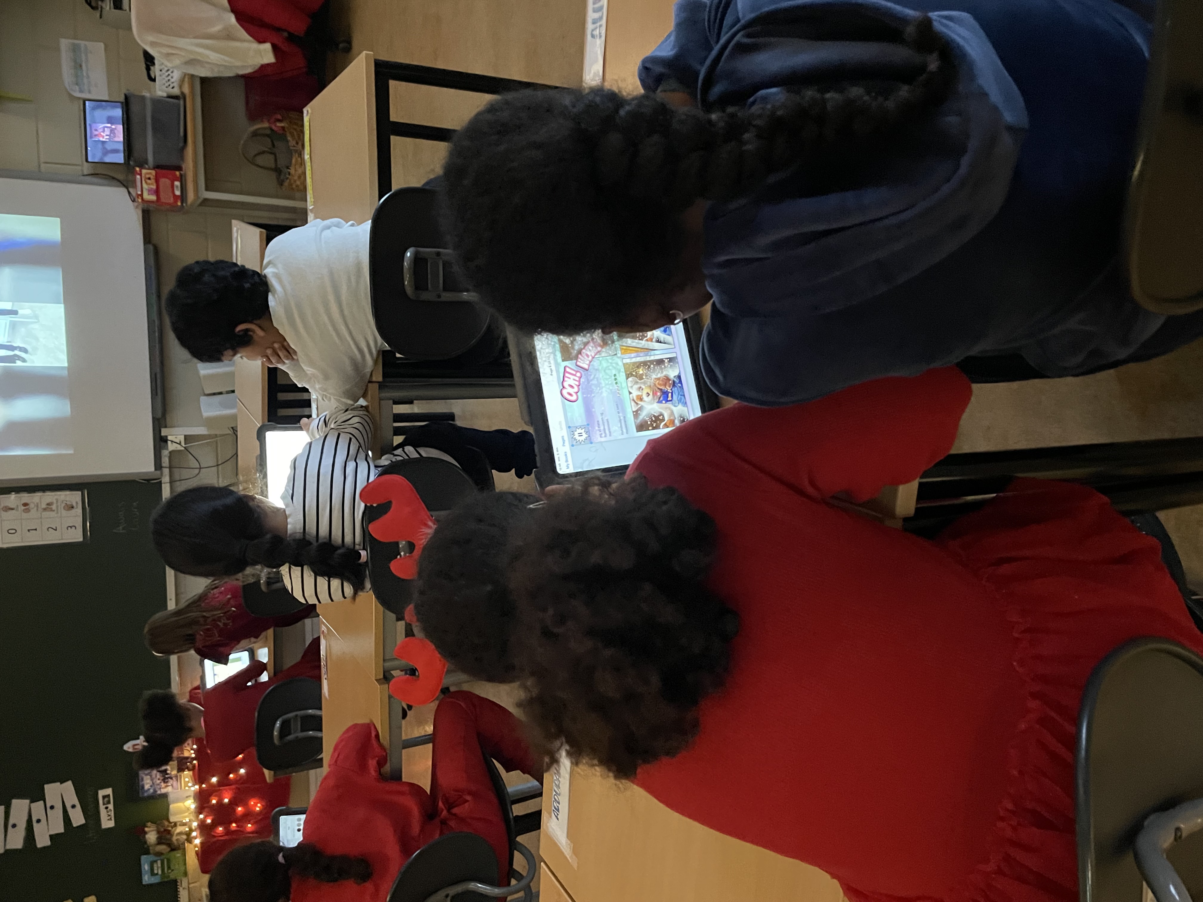 En gruppe mennesker som sitter ved pulter og ser på en skjerm